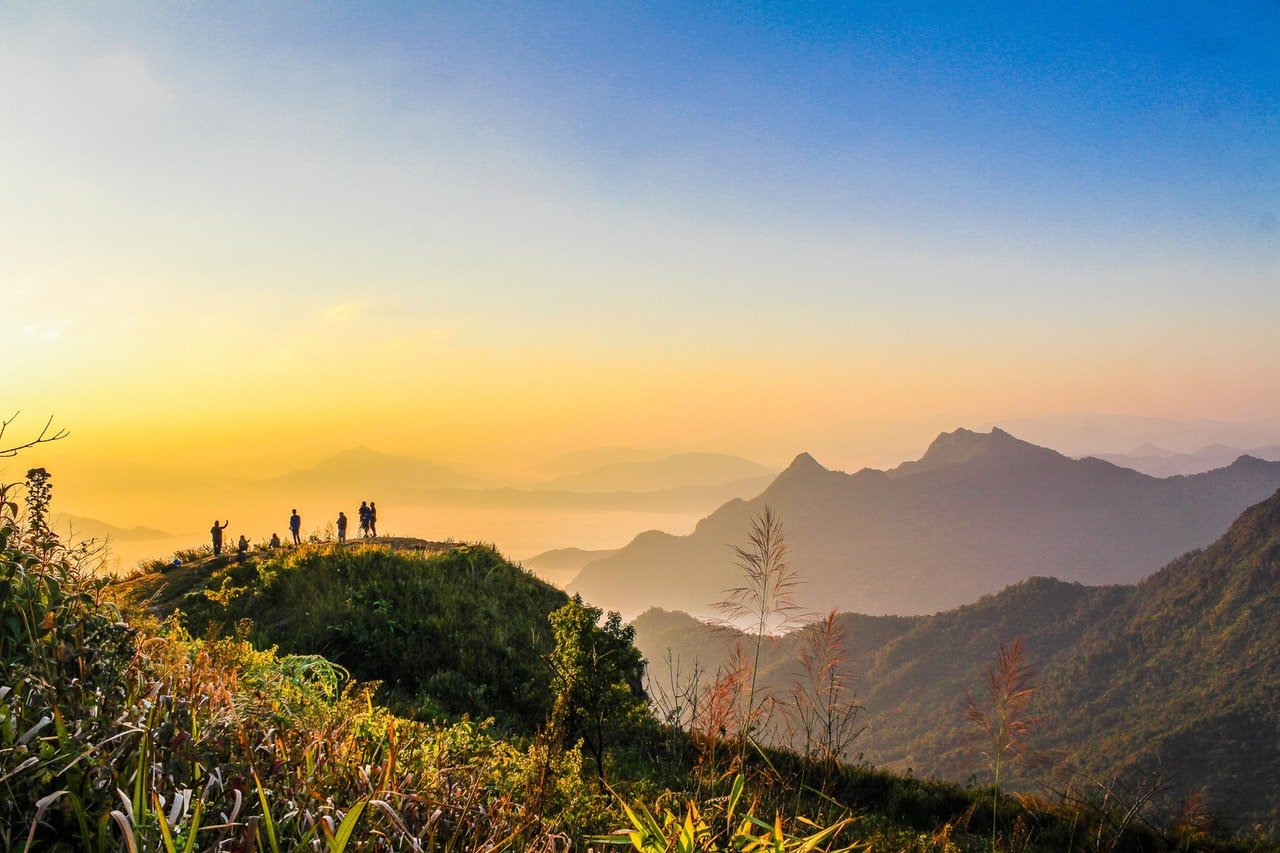 Home Photo Of People Standing On Top Of Mountain Near Grasses 733162